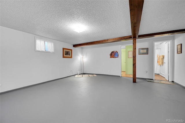 basement with baseboards and a textured ceiling