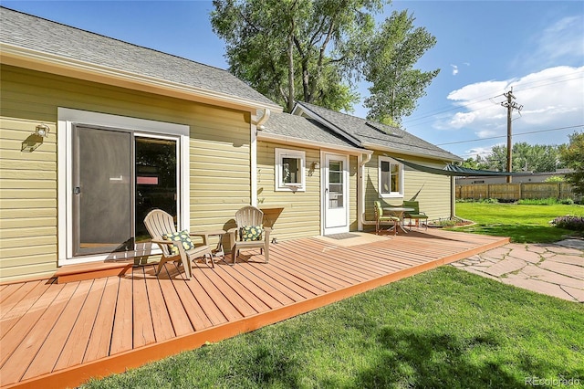 deck featuring a yard and fence