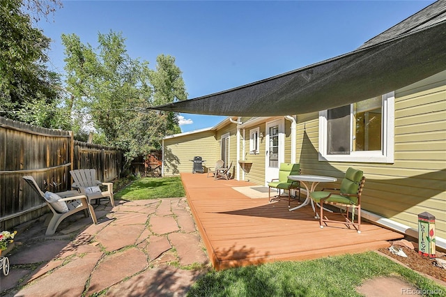 wooden terrace featuring a fenced backyard