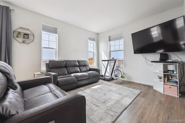 608 N Bersshine Ct, Aurora, CO 80137 - living room featuring wood finished floors and healthy amount of natural light