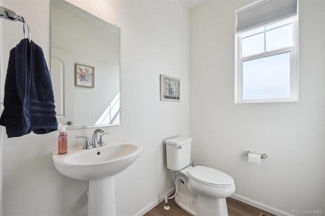 608 N Bersshine Ct, Aurora, CO 80137 - half bathroom with toilet and wood finished floors