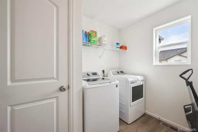 608 N Bersshine Ct, Aurora, CO 80137 - laundry area with washer and clothes dryer and wood finished floors