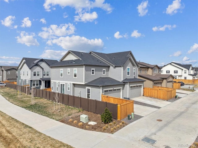608 N Bersshine Ct, Aurora, CO 80137 - multi unit property featuring a residential view, a garage, concrete driveway, and board and batten siding