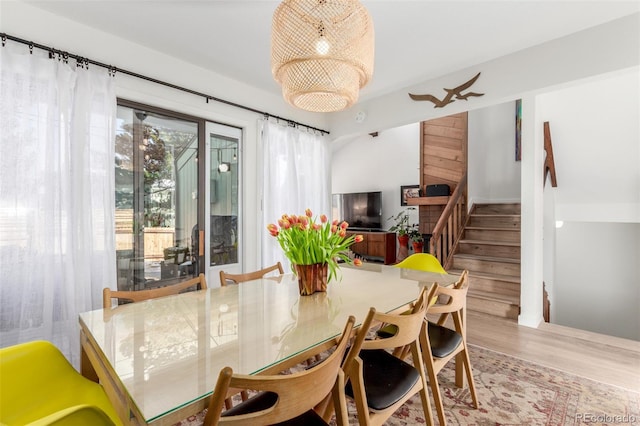 dining space featuring stairs and wood finished floors