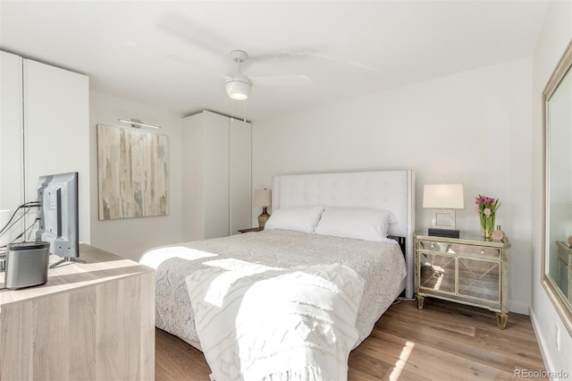 bedroom with light wood-type flooring and ceiling fan