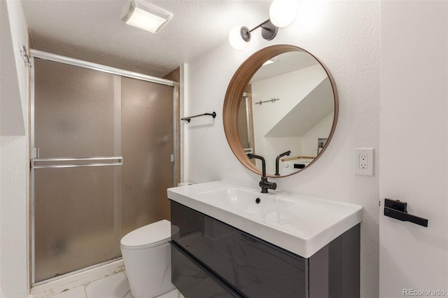 bathroom featuring a stall shower, marble finish floor, a textured ceiling, and toilet