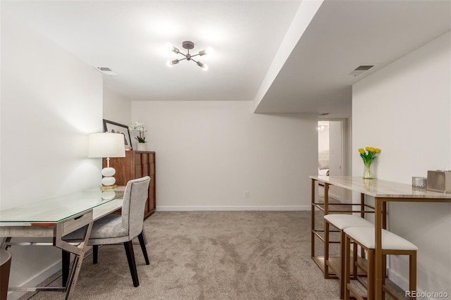 home office with light colored carpet, visible vents, and baseboards