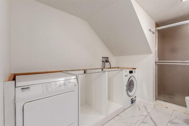 laundry room featuring marble finish floor, baseboards, and washer / clothes dryer