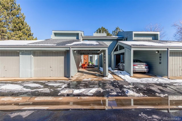 view of front facade featuring a carport and a shingled roof