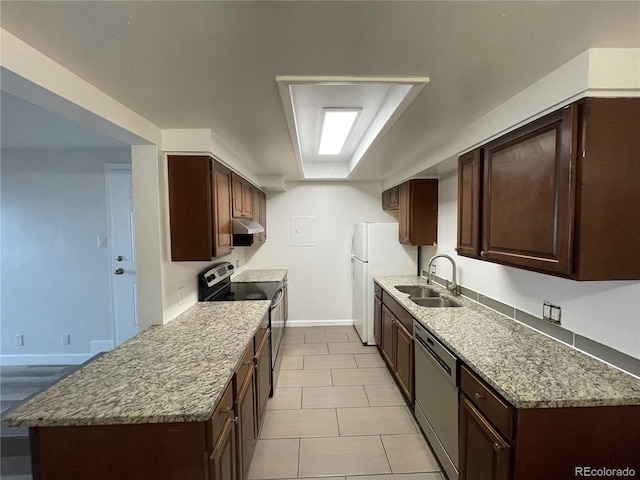 kitchen with under cabinet range hood, a sink, baseboards, dark brown cabinets, and appliances with stainless steel finishes