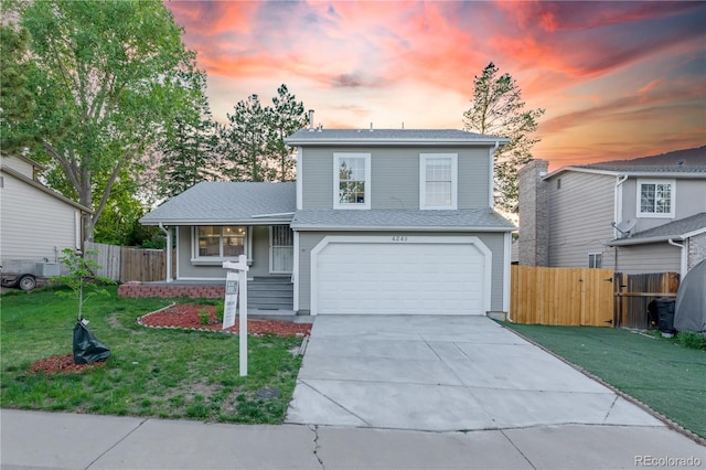 4249 S Biscay Cir, Aurora, CO 80013 - view of front of property with an attached garage, driveway, and a porch