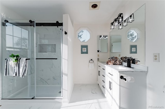 4249 S Biscay Cir, Aurora, CO 80013 - full bath with marble look tiles, vanity, a marble finish shower, and baseboards