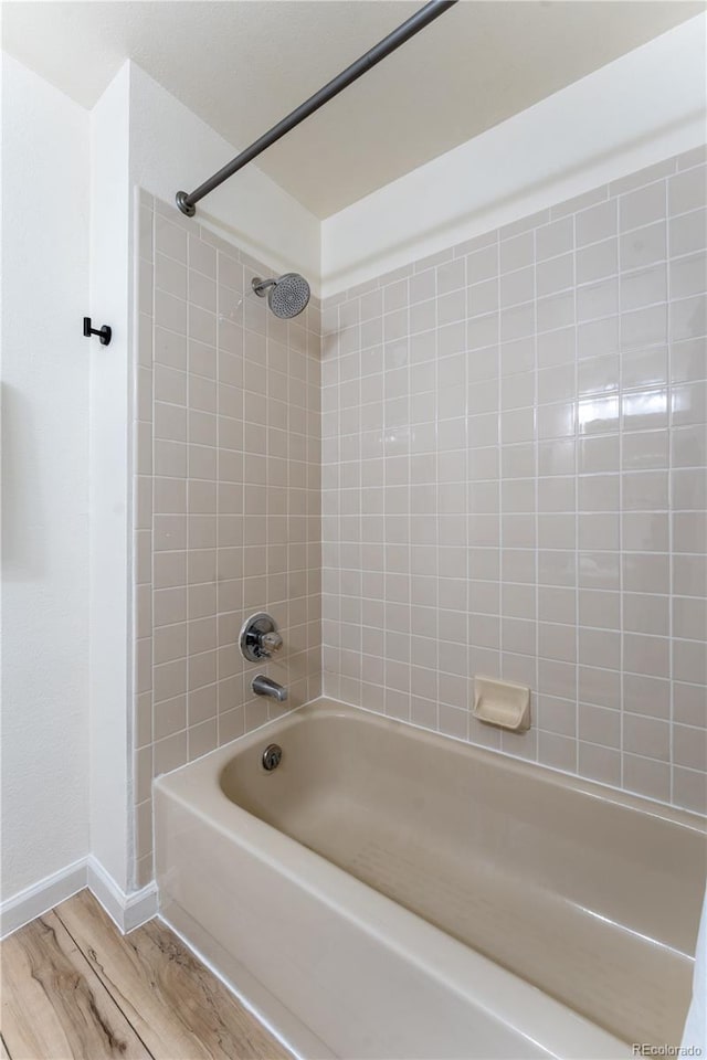 4249 S Biscay Cir, Aurora, CO 80013 - bathroom featuring shower / tub combination, wood finished floors, and baseboards