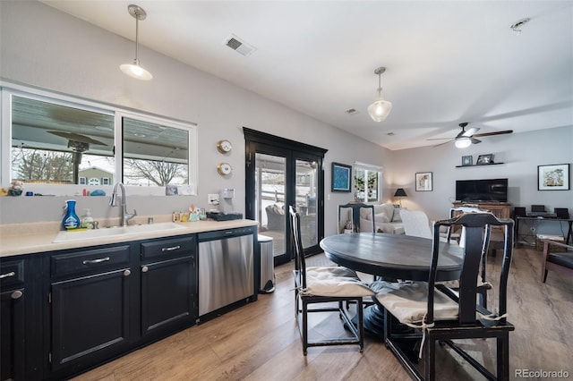 kitchen with sink, a healthy amount of sunlight, dishwasher, and hanging light fixtures