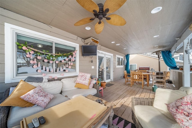 wooden terrace with ceiling fan and an outdoor living space