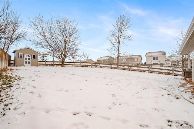 snowy yard with an outdoor structure