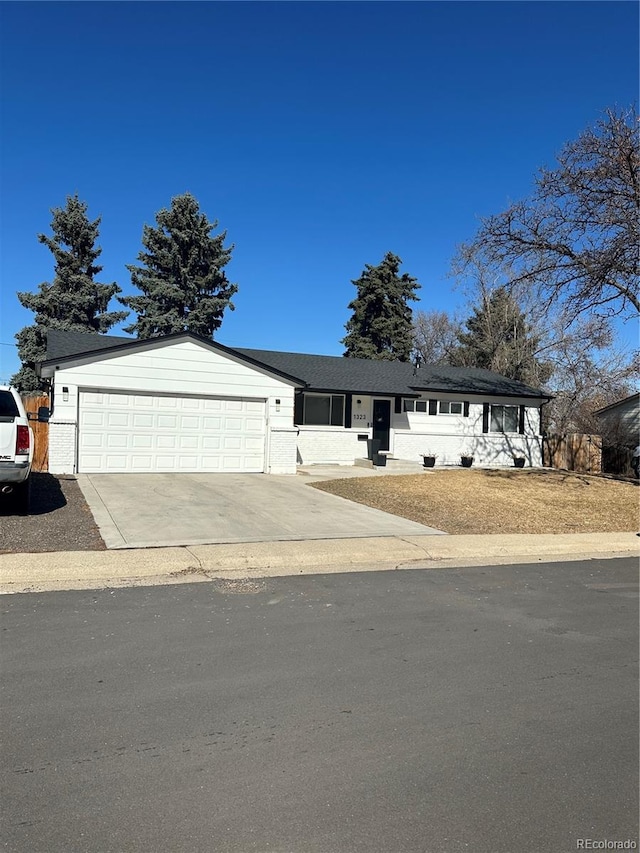 view of front facade featuring concrete driveway and an attached garage