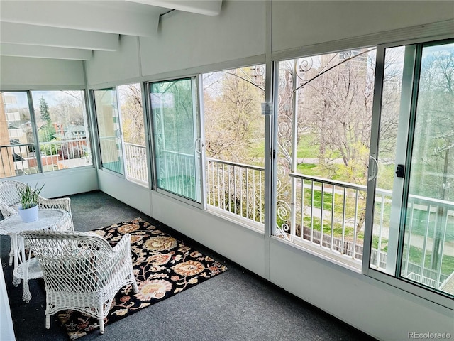 sunroom with beamed ceiling