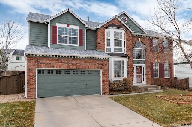 view of front of property featuring a garage and a front lawn