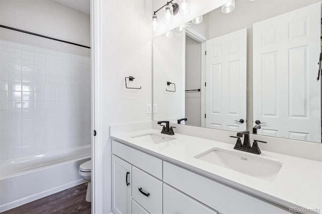 full bathroom with vanity, hardwood / wood-style flooring, toilet, and shower / bath combination