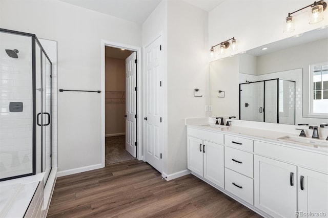 bathroom featuring vanity, hardwood / wood-style floors, and walk in shower