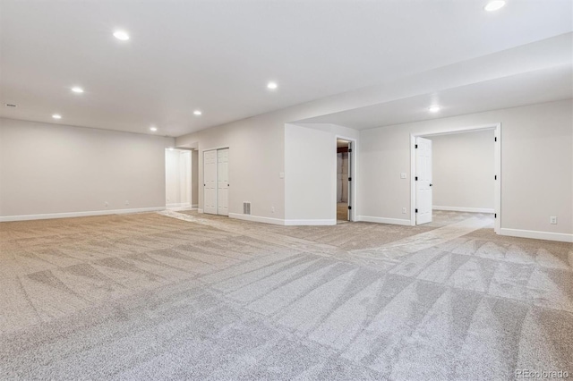 empty room featuring light carpet