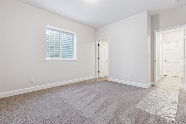 spare room featuring light colored carpet