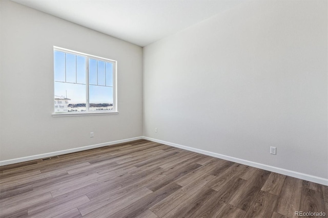 empty room with hardwood / wood-style flooring