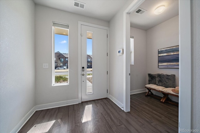 entryway with visible vents, dark wood-type flooring, and baseboards