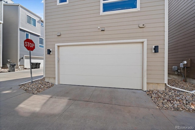 garage featuring concrete driveway