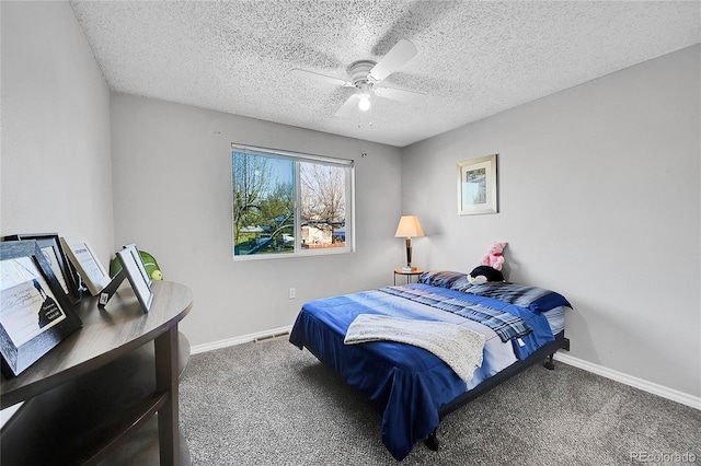 carpeted bedroom with ceiling fan and a textured ceiling