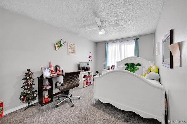 carpeted bedroom with ceiling fan and a textured ceiling