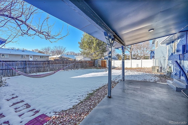 yard layered in snow with a storage unit