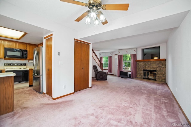 210 W Jamison Cir Unit 41, Littleton, CO 80120 - unfurnished living room featuring light carpet, a ceiling fan, and a stone fireplace