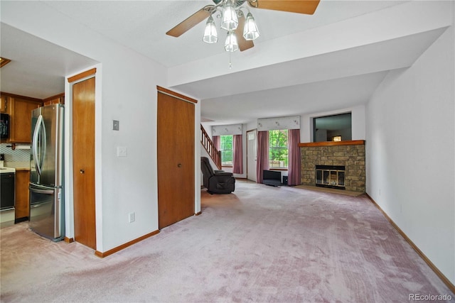 210 W Jamison Cir Unit 41, Littleton, CO 80120 - unfurnished living room featuring light colored carpet, a ceiling fan, a fireplace, and stairs