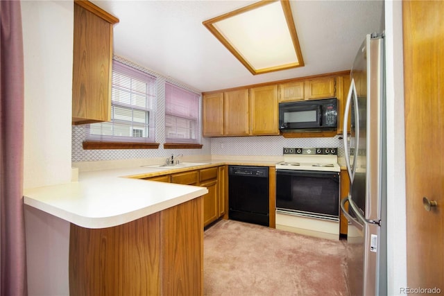 210 W Jamison Cir Unit 41, Littleton, CO 80120 - kitchen featuring black appliances, a peninsula, light countertops, light carpet, and decorative backsplash
