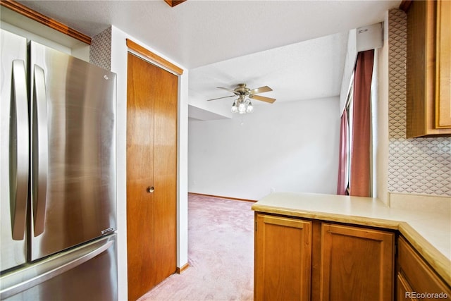 210 W Jamison Cir Unit 41, Littleton, CO 80120 - kitchen with freestanding refrigerator, a ceiling fan, light colored carpet, light countertops, and brown cabinets