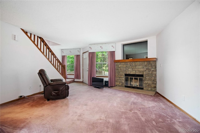 210 W Jamison Cir Unit 41, Littleton, CO 80120 - unfurnished living room featuring carpet flooring, stairs, and a stone fireplace