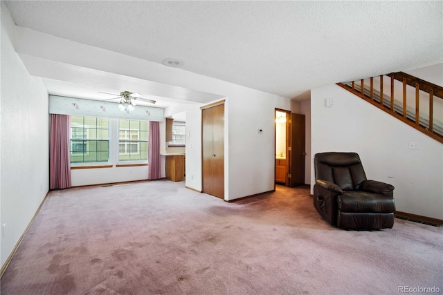 210 W Jamison Cir Unit 41, Littleton, CO 80120 - unfurnished living room with carpet, ceiling fan, stairway, and a textured ceiling