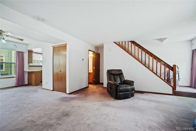 210 W Jamison Cir Unit 41, Littleton, CO 80120 - unfurnished living room with carpet flooring, stairway, and ceiling fan