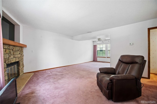 210 W Jamison Cir Unit 41, Littleton, CO 80120 - sitting room featuring a stone fireplace, carpet floors, a ceiling fan, and a textured ceiling