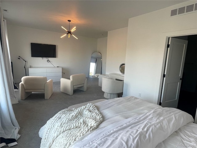 bedroom with an inviting chandelier and carpet floors