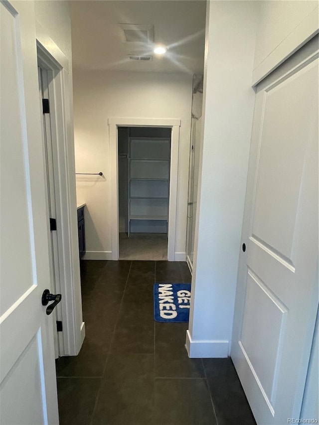 hallway with dark tile patterned flooring