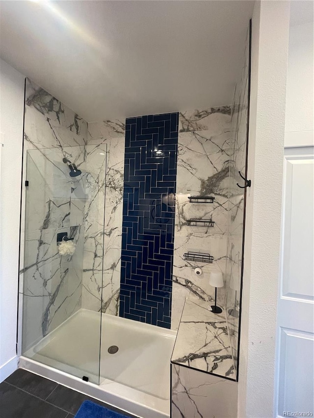 bathroom with a tile shower