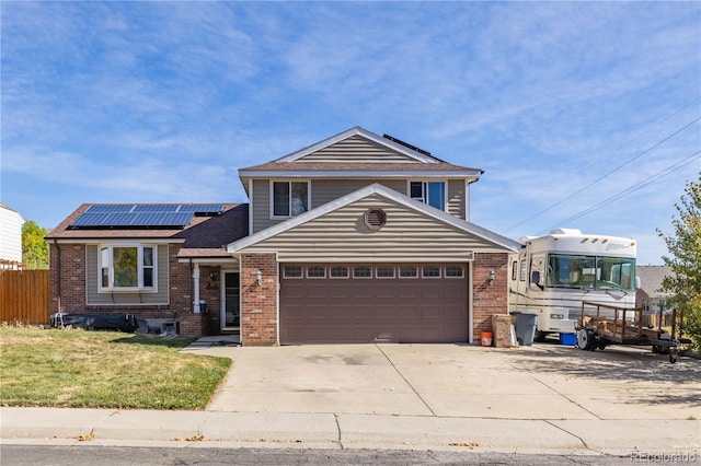 view of front facade featuring solar panels, a garage, and a front yard