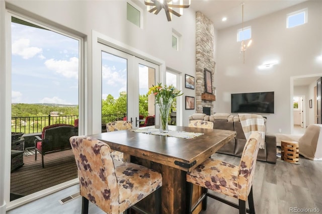 3630 Mesa Verde Rd, Monument, CO 80132 - dining space with a towering ceiling, light wood finished floors, and french doors