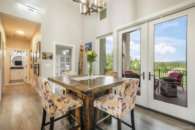 3630 Mesa Verde Rd, Monument, CO 80132 - dining room featuring french doors, wood finished floors, a high ceiling, and a chandelier
