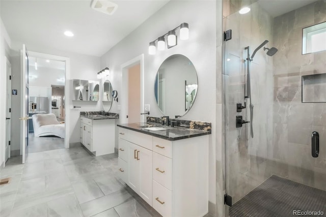 3630 Mesa Verde Rd, Monument, CO 80132 - full bath with a shower stall, two vanities, connected bathroom, and recessed lighting