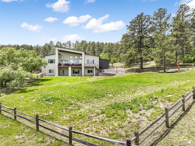 3630 Mesa Verde Rd, Monument, CO 80132 - rear view of house featuring stucco siding and view of wooded area