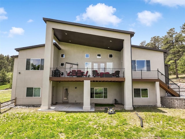 3630 Mesa Verde Rd, Monument, CO 80132 - back of house with stucco siding, a lawn, and a patio